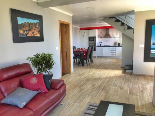 a living room with a couch and a dining room at Lucilia's House in Calheta
