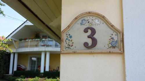 a house with a number on the side of it at Tündérlak Vendégház in Balatonfüred