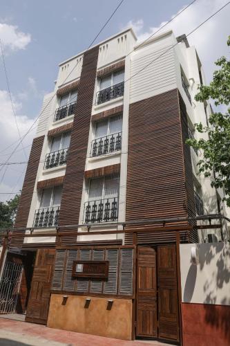 a building with wooden shutters on it at The Mandeville in Kolkata