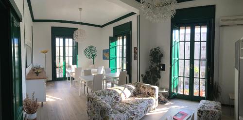 a living room with a couch and a table at Cosmopolitan Palermo in Palermo
