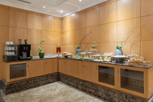 a buffet line with food on display in a room at Park Inn by Radisson Makkah Al Naseem in Makkah