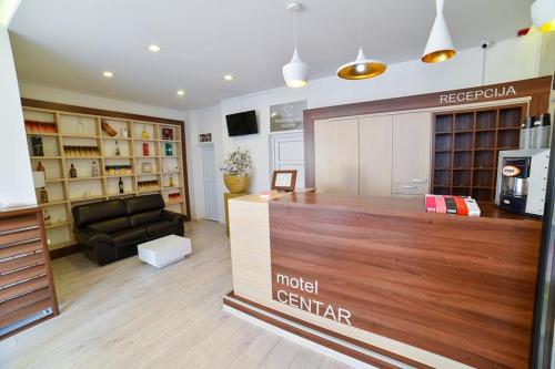a store with a lobby with a couch and a counter at Motel Centar in Bijeljina