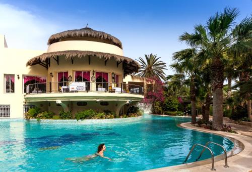 a woman swimming in the pool at a resort at TUI MAGIC LIFE Africana in Hammamet
