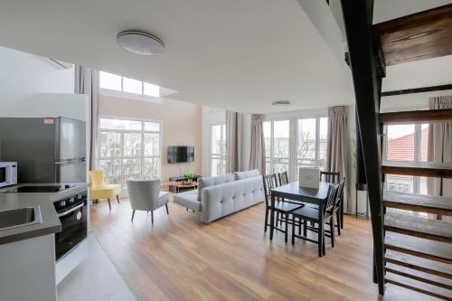 a kitchen and living room with a couch and a table at House of Palm - One of a Kind in Tel Aviv