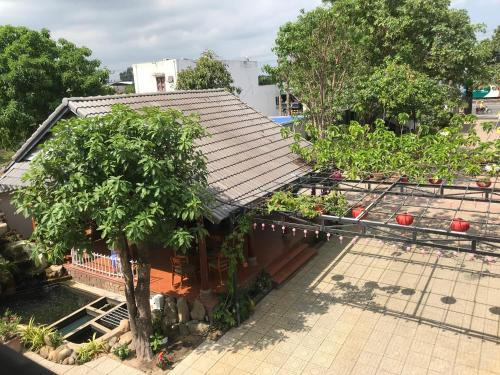 a house with a garden with trees in it at HOTEL AN HOÀ II in Ba Ria
