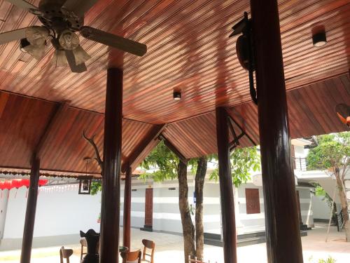 a wooden ceiling in a pavilion with trees at HOTEL AN HOÀ II in Ba Ria