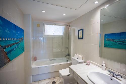 a bathroom with a sink toilet and a bath tub at Beach View Playa Del Moral in Estepona