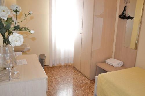 a room with a vase of flowers on a table at Hotel Santa Lucia in Venice