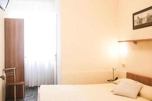 a bedroom with two beds and a window at Hotel Santa Lucia in Venice