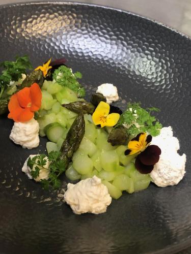 a plate of food with vegetables and flowers on it at Hôtel Saphir Lyon in Lyon