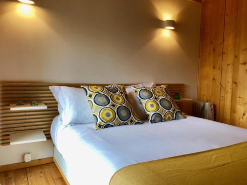 a bedroom with a white bed with pillows on it at Quinta Lamosa Agroturismo in Arcos de Valdevez