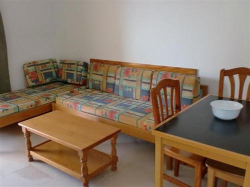 a living room with a couch and a table and chairs at Apartamentos Gemelos IV - Fincas Arena in Benidorm