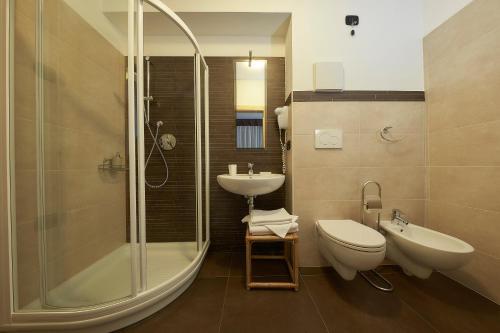 a bathroom with a shower and a toilet and a sink at Abete Rosso in Rabbi