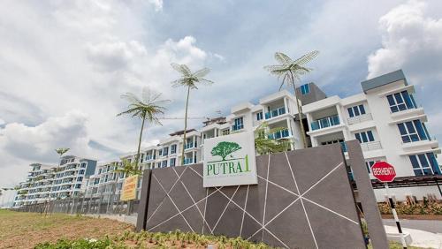 a hotel with palm trees in front of it at HOMESTAY @ BANDAR SERI PUTRA KAJANG in Kajang