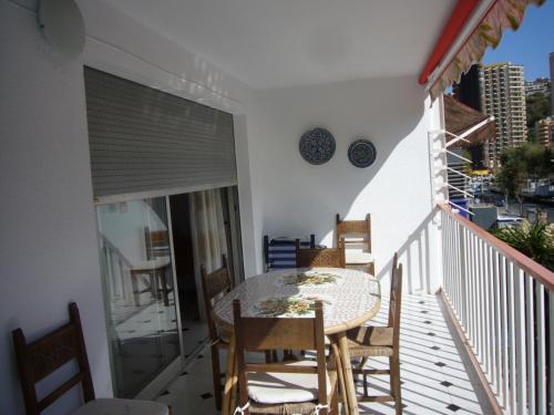 a balcony with a table and chairs on a balcony at Edimar - Fincas Arena in Benidorm