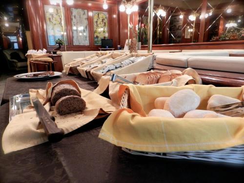 a table topped with lots of different types of food at Hotel Italia in Stradella