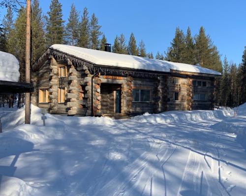 a log cabin in the snow with snow at Casa Levi Luxury Chalet in Levi