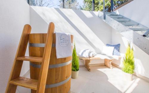 a room with a wooden chair and a barrel at Hotel Berlin Tegernsee in Rottach-Egern