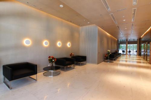 a lobby with couches and flowers on the wall at Dazzler by Wyndham Lima San Isidro in Lima