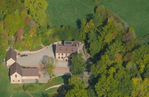 an aerial view of a large house in the forest at The Larches Ledbury in Ledbury