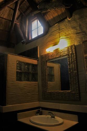 a bathroom with a sink and a mirror at Chinaka Game Lodge in Vivo