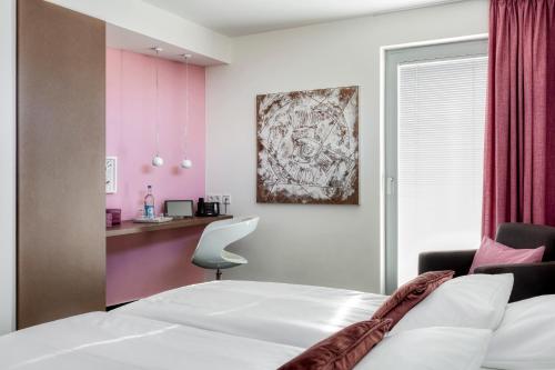 a hotel room with a bed and a desk at Hotel F-RITZ in Schleswig