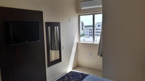 Center Patos Hotelにあるテレビまたはエンターテインメントセンター