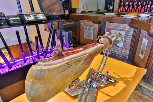 a large fish on a table in a store at Hostería El Bodegón De Gredos in Arenas de San Pedro