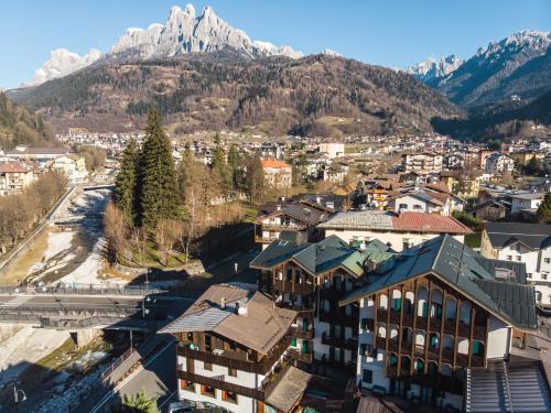an aerial view of a town with mountains in the background at Hotel Isolabella Wellness in Fiera di Primiero