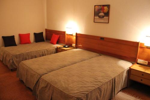 Кровать или кровати в номере Hotel Bom Sucesso