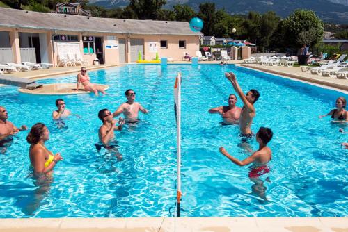 a group of people in a swimming pool at L'Ecrin du Lac in Chorges