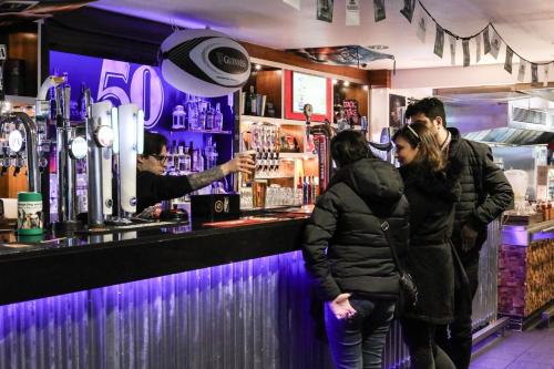 a group of people standing at a bar at a&o Edinburgh City in Edinburgh