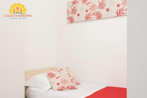 a room with a white couch with a red rug at Casa in Maremma Tuscany Village in Scarlino