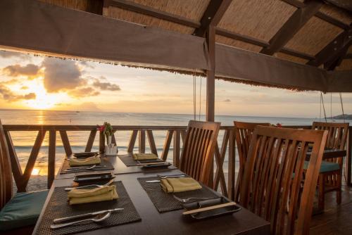 a table on the beach with a view of the ocean at Coral Strand Smart Choice in Beau Vallon