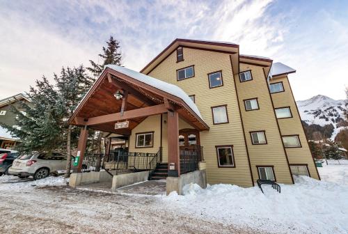a large building with snow in front of it at Timberline by FantasticStay in Fernie
