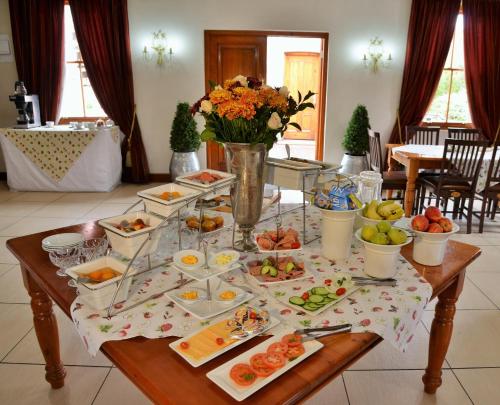 a table with many plates of food on it at Die Kliphuis in Standerton