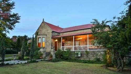 a stone house with a red roof at Die Kliphuis in Standerton