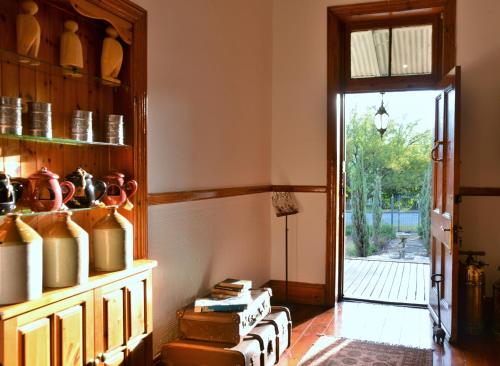 a room with a book shelf with pots and pans at Die Kliphuis in Standerton