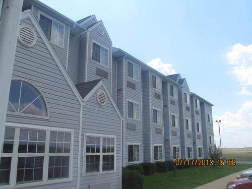 a large gray building with windows on the side of it at Microtel Inn by Wyndham Champaign in Champaign
