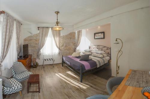 a bedroom with a bed and a table and chairs at Bossa Studio Apartments in Split