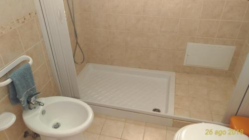 a bathroom with a sink and a toilet and a shower at Villetta Carati in Torre dell'Orso
