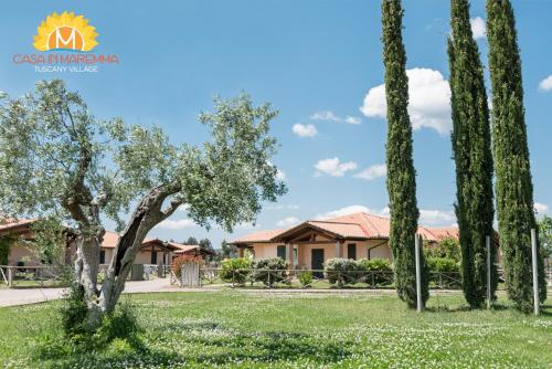 a villa withinia trees in front of a house at Casa in Maremma Tuscany Village in Scarlino