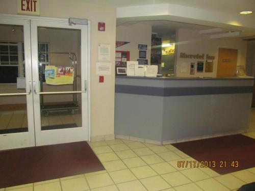 an entrance to a store with a counter in a building at Microtel Inn by Wyndham Champaign in Champaign