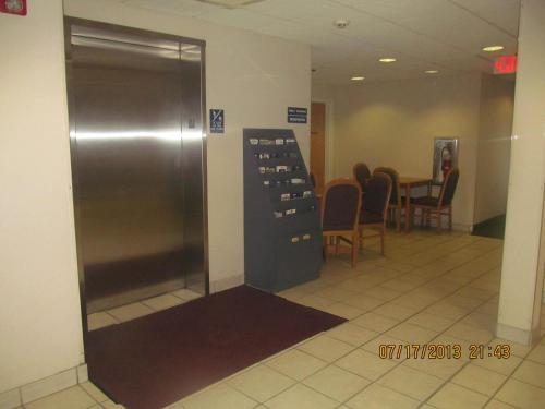 an elevator in a room with a table and chairs at Microtel Inn by Wyndham Champaign in Champaign