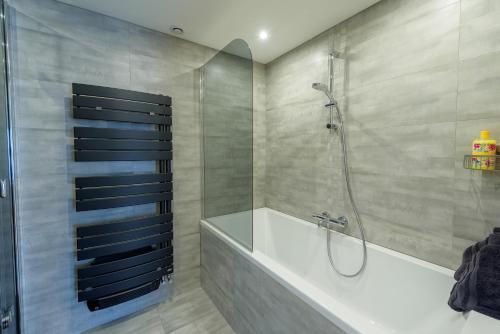 a bathroom with a shower and a bath tub at Villa Marine in Plouguin