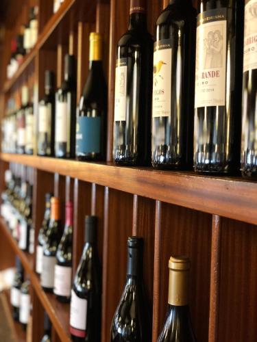 a bunch of bottles of wine are lined up on a shelf at Hotel Eurosol Seia Camelo in Seia