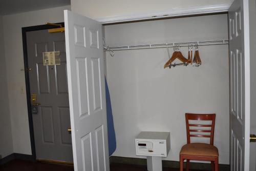 a room with a door and a chair and a desk at Country Inn & Suites by Radisson, Hagerstown, MD in Hagerstown