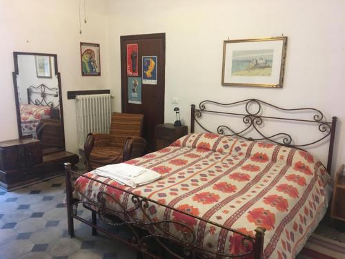 a bedroom with a bed and a chair at B&B Del Teatro in Sulmona