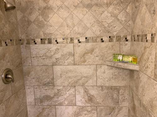 a bathroom with a shower with marble tiles at Twin Palms at Siesta in Siesta Key