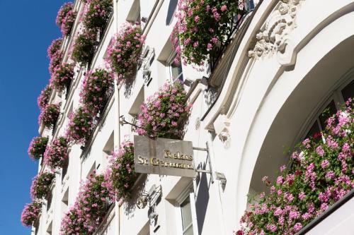 a building with flowers on the side of it at Hôtel Le Relais Saint-Germain in Paris